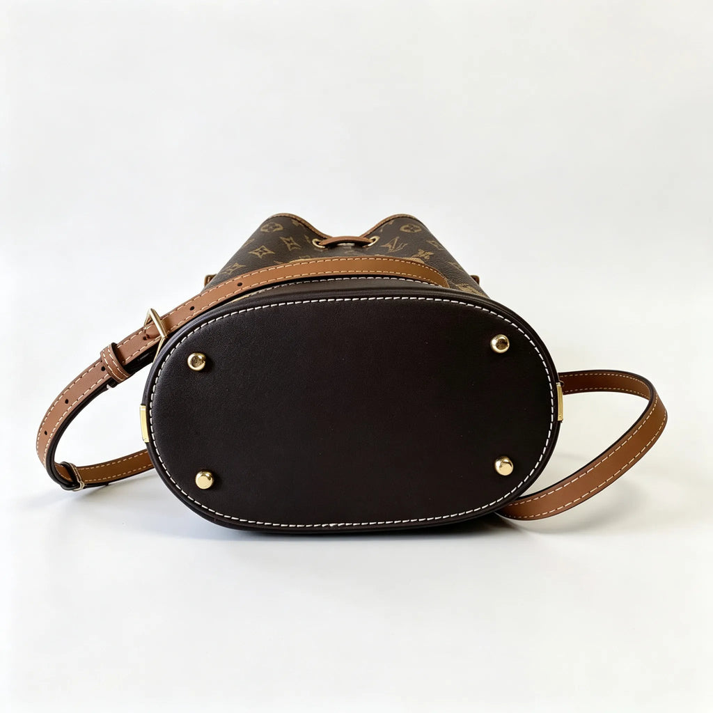 Tory Burch T Monogram | Off-white base with hazelnut brown monogram jacquard pattern and dark brown leather trim  drawstring closure versatile handbag suitable for commuting and travel