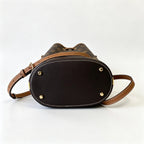 Tory Burch T Monogram | Off-white base with hazelnut brown monogram jacquard pattern and dark brown leather trim  drawstring closure versatile handbag suitable for commuting and travel