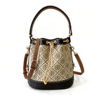 Tory Burch T Monogram | Off-white base with hazelnut brown monogram jacquard pattern and dark brown leather trim  drawstring closure versatile handbag suitable for commuting and travel