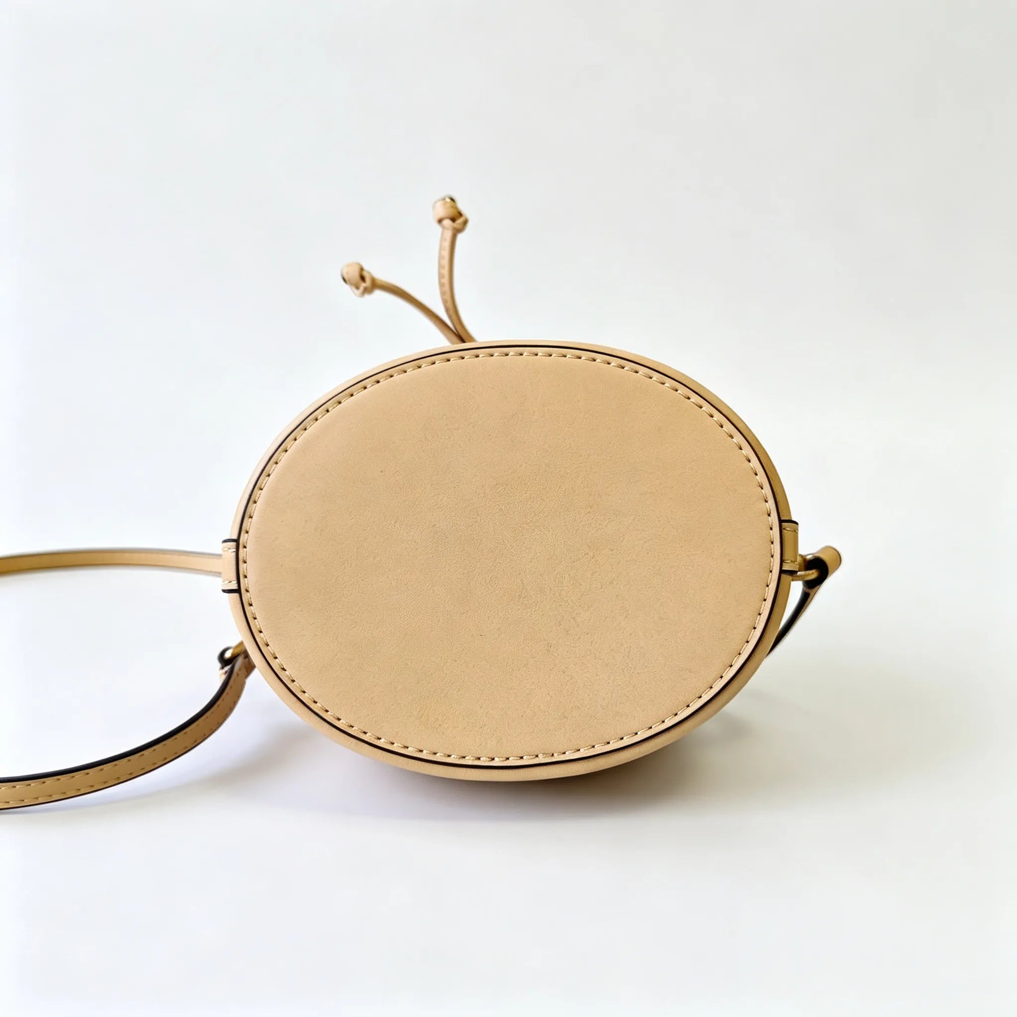 Tory Burch T Monogram ivory and beige Monogram canvas adorned with gold heart studs drawstring closure and detachable shoulder strap women's designer handbag