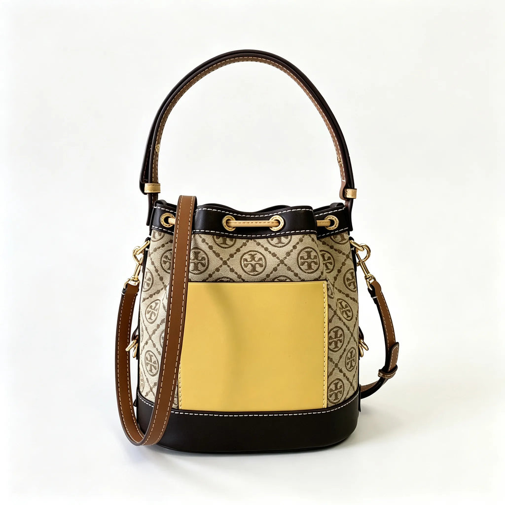 Tory Burch T Monogram | Off-white base with hazelnut brown monogram jacquard pattern and dark brown leather trim  drawstring closure versatile handbag suitable for commuting and travel