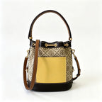 Tory Burch T Monogram | Off-white base with hazelnut brown monogram jacquard pattern and dark brown leather trim  drawstring closure versatile handbag suitable for commuting and travel