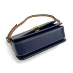 Tory Burch navy and beige Monogram canvas with an adjustable leather shoulder strap convertible into a crossbody or shoulder bag women's style