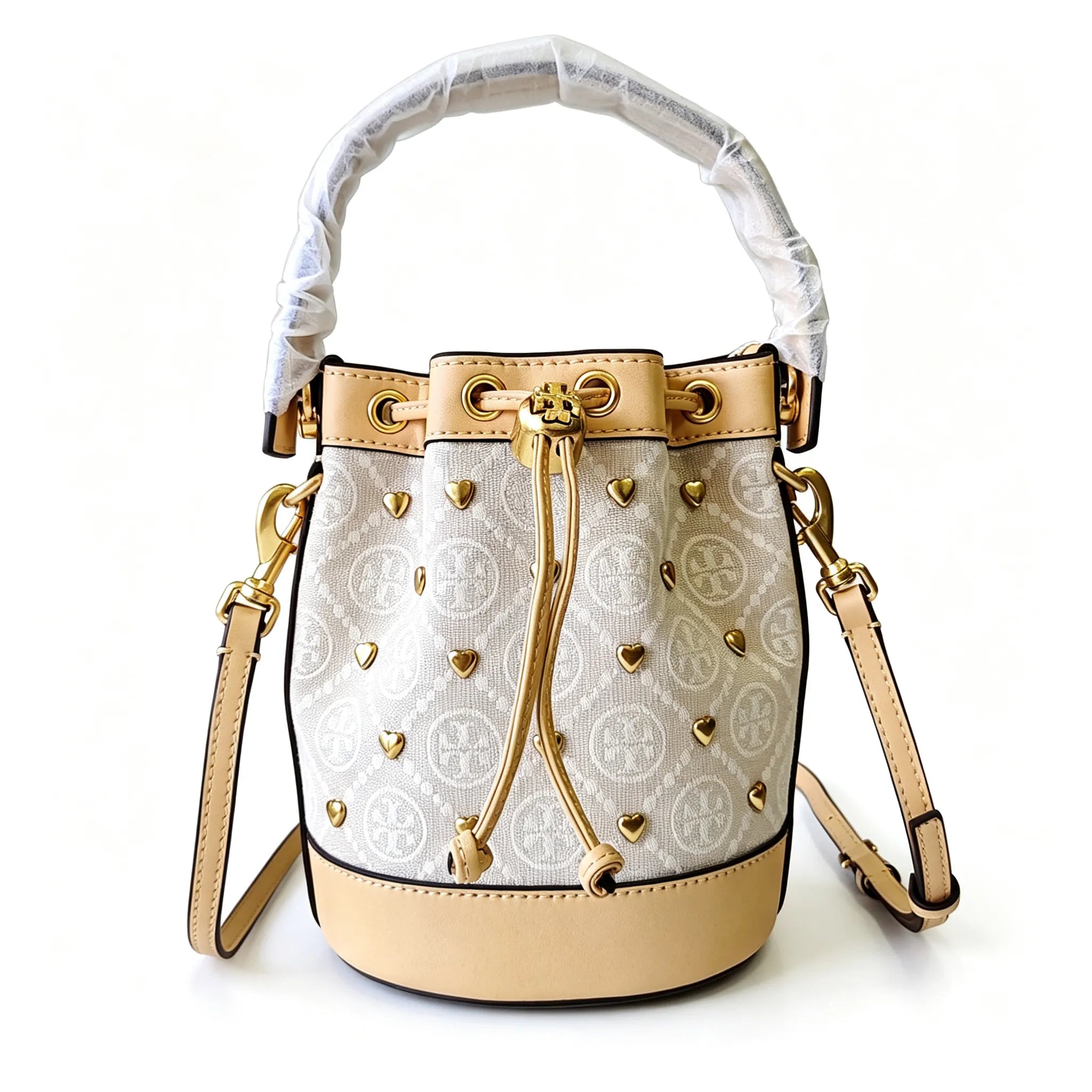 Tory Burch T Monogram ivory and beige Monogram canvas adorned with gold heart studs drawstring closure and detachable shoulder strap women's designer handbag