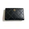 Tory Burch Fleming black quilted leather clutch with multiple card slots and a zippered coin pocket