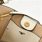 Tory Burch McGraw | Off-white pebbled leather with an adjustable shoulder strap and top handle  offering multiple carrying options  A women's designer handbag  perfect for work and weekend getaways