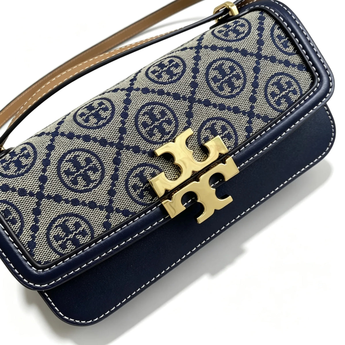 Tory Burch navy and beige Monogram canvas with an adjustable leather shoulder strap convertible into a crossbody or shoulder bag women's style