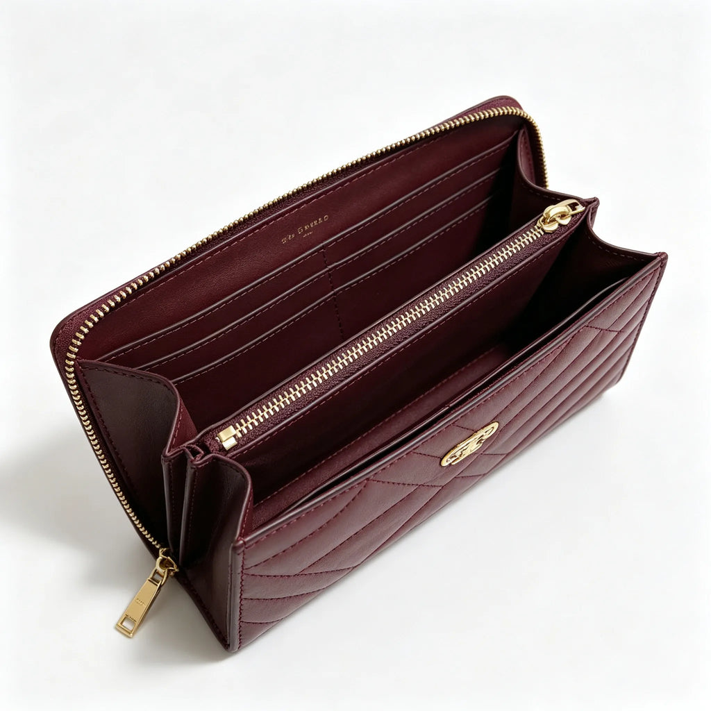 Tory Burch Kira burgundy quilted Nappa leather clutch with multiple card slots and a zippered coin purse