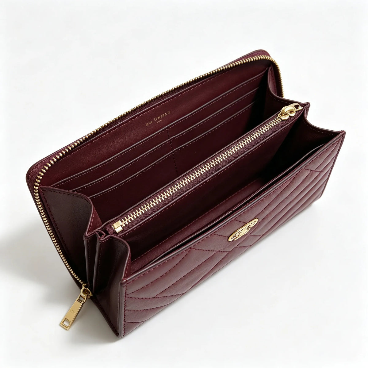 Tory Burch Kira burgundy quilted Nappa leather clutch with multiple card slots and a zippered coin purse