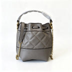 Tory Burch Willa | Grey-brown lambskin leatheradorned with a gold double-T logo detachable chain shoulder strap  drawstring closure  women's designer handbag