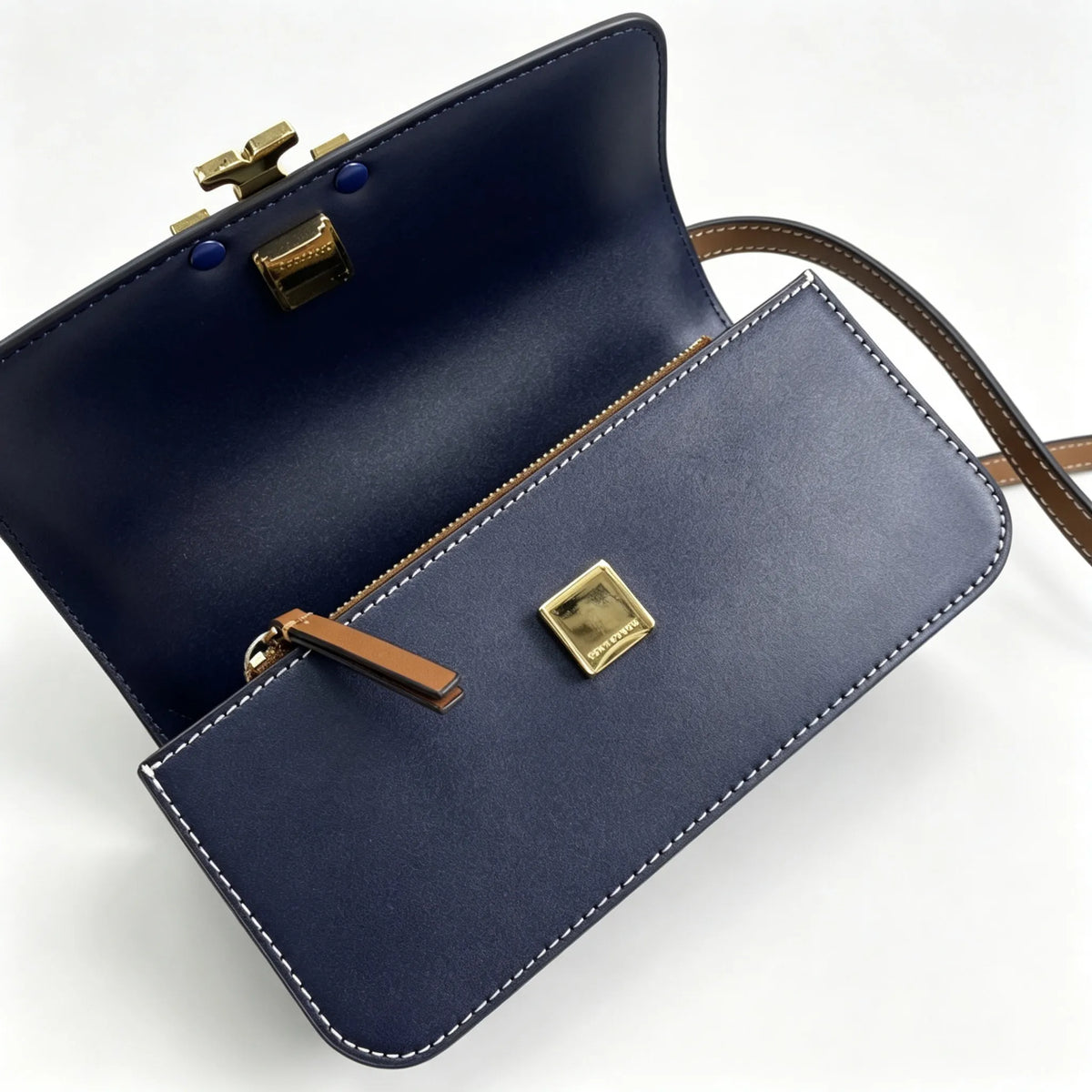 Tory Burch navy and beige Monogram canvas with an adjustable leather shoulder strap convertible into a crossbody or shoulder bag women's style