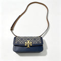 Tory Burch navy and beige Monogram canvas with an adjustable leather shoulder strap convertible into a crossbody or shoulder bag women's style