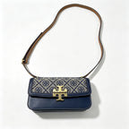 Tory Burch navy and beige Monogram canvas with an adjustable leather shoulder strap convertible into a crossbody or shoulder bag women's style