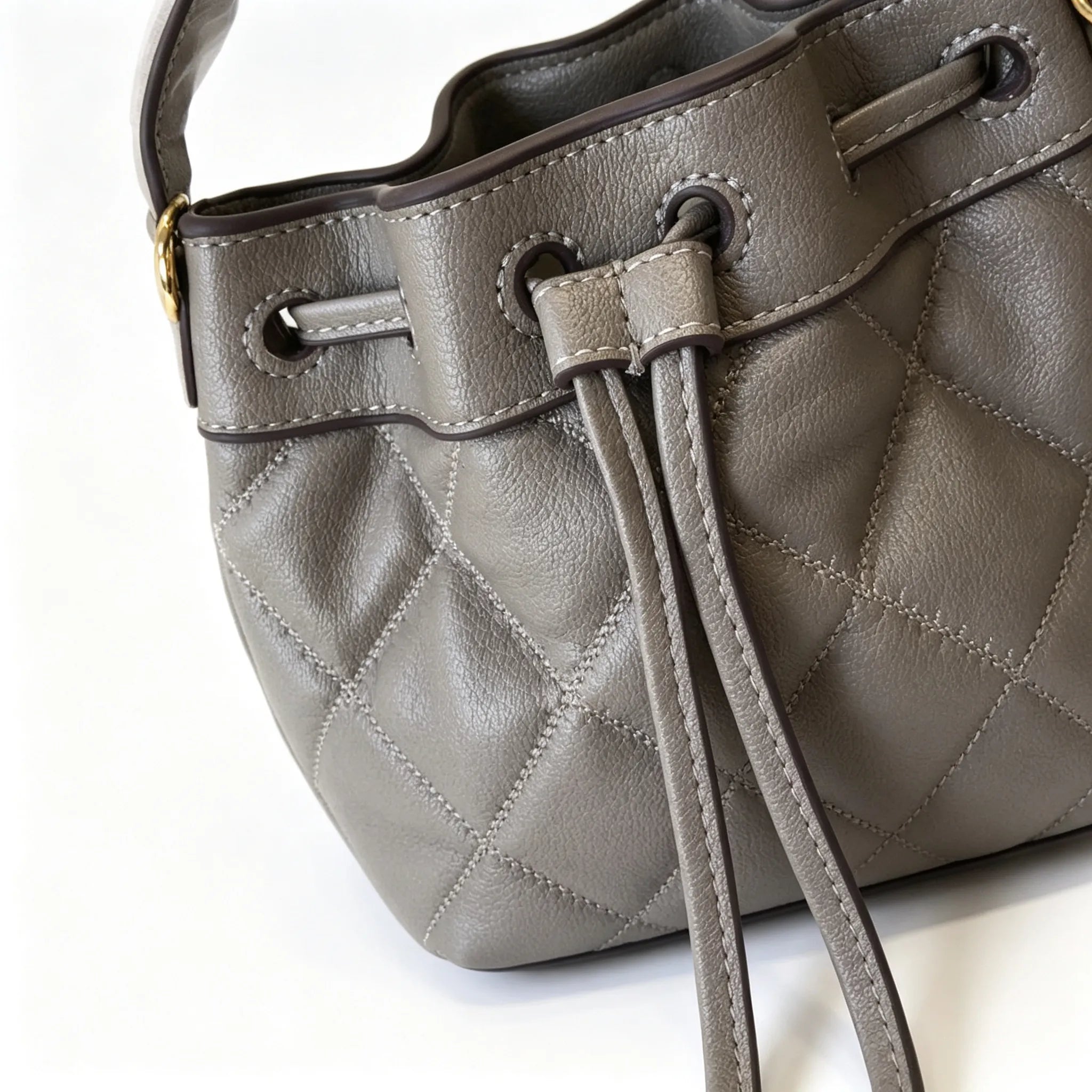 Tory Burch Willa | Grey-brown lambskin leatheradorned with a gold double-T logo detachable chain shoulder strap  drawstring closure  women's designer handbag
