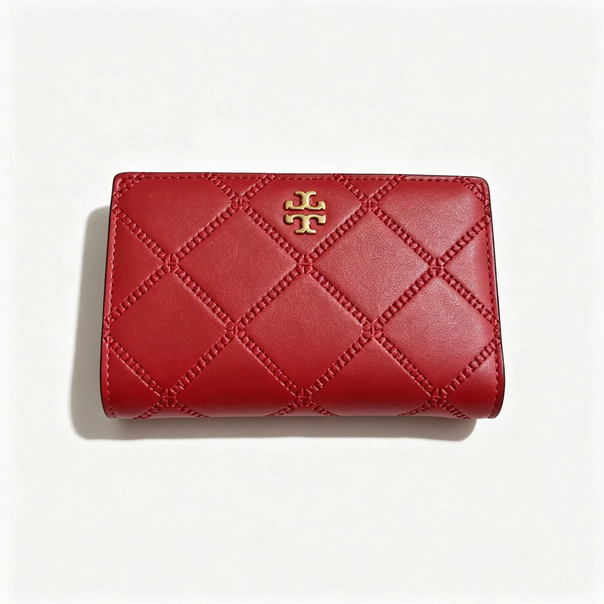 Tory Burch Fleming black quilted leather clutch with multiple card slots and a zippered coin pocket