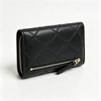 Tory Burch Fleming black quilted leather clutch with multiple card slots and a zippered coin pocket
