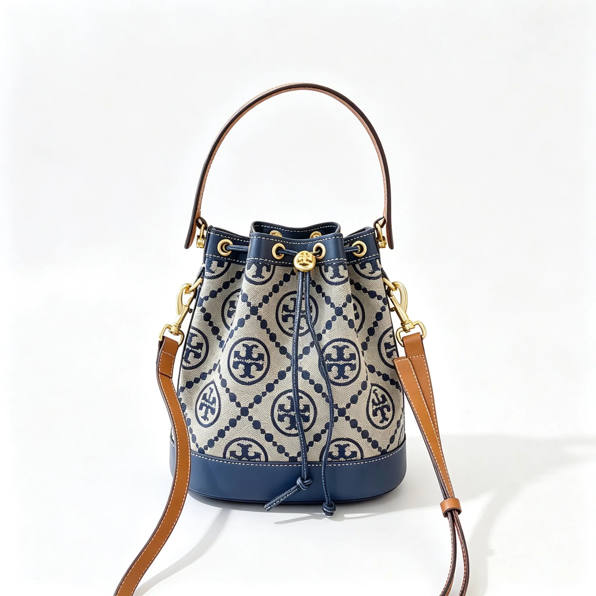 Tory Burch T Monogram | Navy blue and beige Monogram fabric leather trim  adjustable shoulder strap drawstring closure  women's designer mini jacquard bucket bag