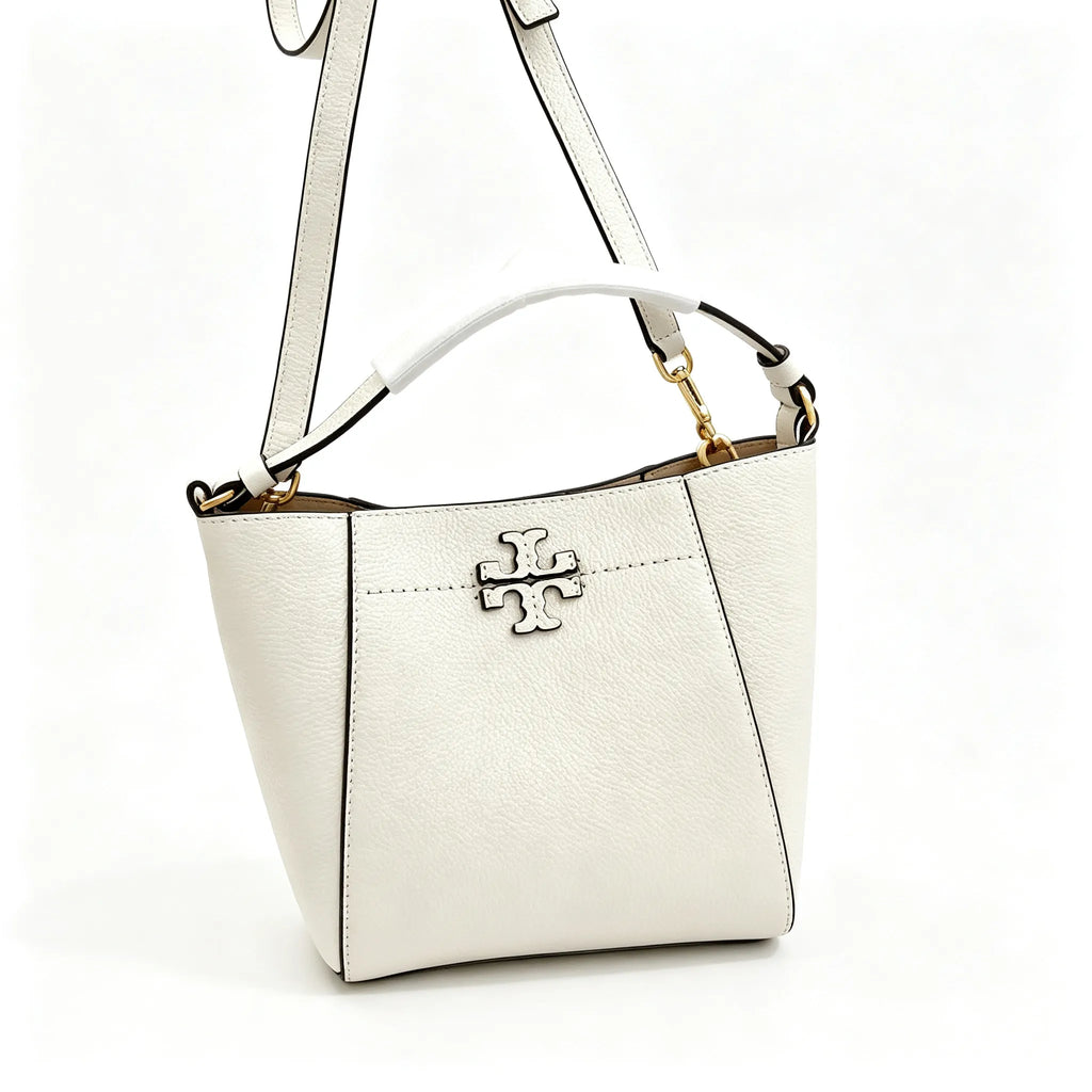 Tory Burch McGraw | Off-white pebbled leather with an adjustable shoulder strap and top handle  offering multiple carrying options  A women's designer handbag  perfect for work and weekend getaways