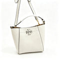 Tory Burch McGraw | Off-white pebbled leather with an adjustable shoulder strap and top handle  offering multiple carrying options  A women's designer handbag  perfect for work and weekend getaways