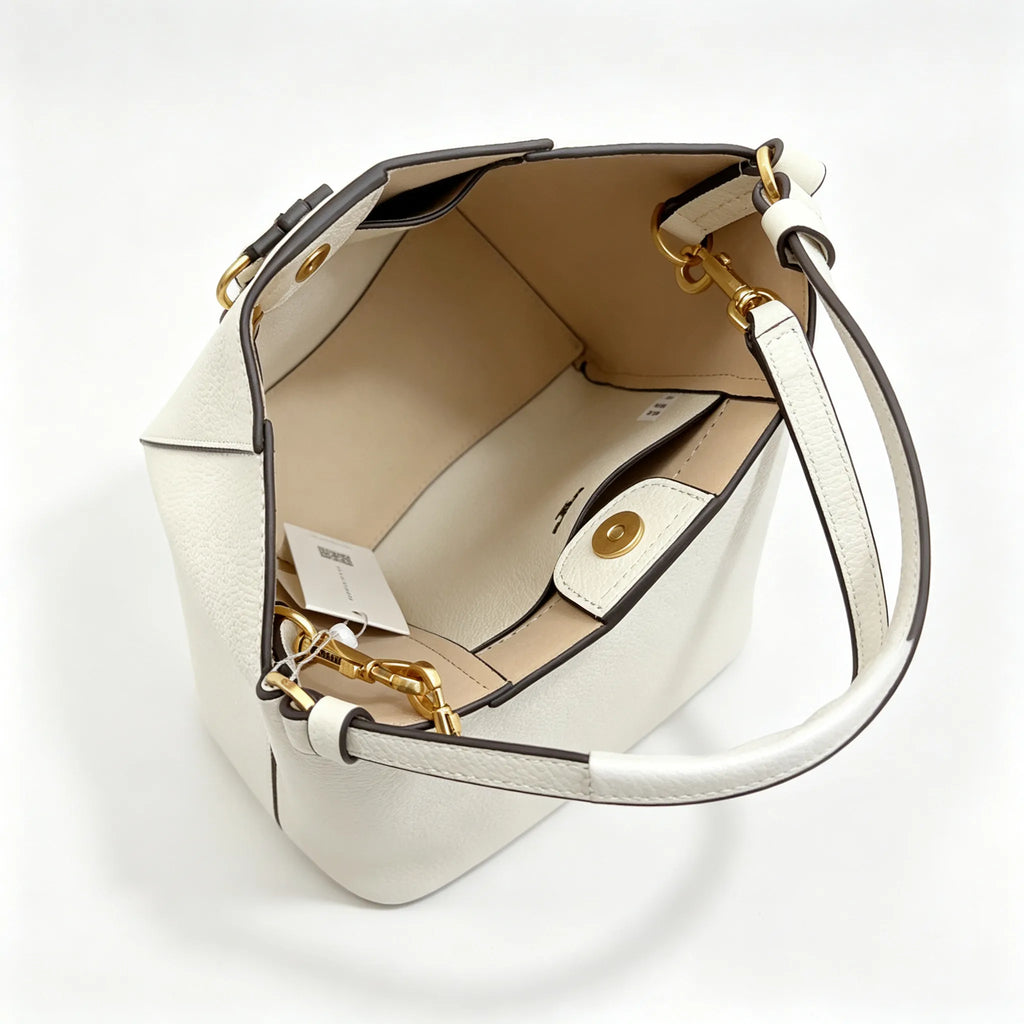 Tory Burch McGraw | Off-white pebbled leather with an adjustable shoulder strap and top handle  offering multiple carrying options  A women's designer handbag  perfect for work and weekend getaways
