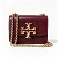 Tory Burch Eleanor burgundy with a gold double-T adjustable twist chain shoulder strap offering multiple carrying options for women