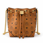 MCM Soft Berlin Visetos Mini Bucket Bag Cognac | Gold Chain Shoulder Bag for Women — Designer Coated Canvas Drawstring Crossbody