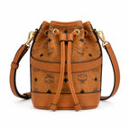 MCM Dessau Visetos Bucket Bag Mini | Drawstring Crossbody Shoulder Bag in Cognac — Designer Coated Canvas & Leather Handbag
