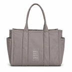 Marc Jacobs | Grey quilted nylon  embossed logo  double handles  exterior pocket  women's commuter tote bag