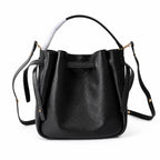 Tory Burch Romy | Black pebbled leather with adjustable shoulder strap and drawstring closure  women's designer shoulder bag
