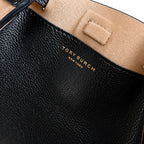 Tory Burch Romy | Black pebbled leather with adjustable shoulder strap and drawstring closure  women's designer shoulder bag