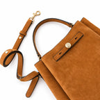 Tory Burch Romy | Caramel brown with adjustable shoulder strap and drawstring closure  women's designer suede bucket bag