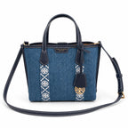 Tory Burch Perry | Blue washed denim  white embroidered T-logo stripes  navy leather trim and gold charm  double handles and adjustable shoulder strap  women's designer shoulder bag