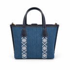 Tory Burch Perry | Blue washed denim  white embroidered T-logo stripes  navy leather trim and gold charm  double handles and adjustable shoulder strap  women's designer shoulder bag