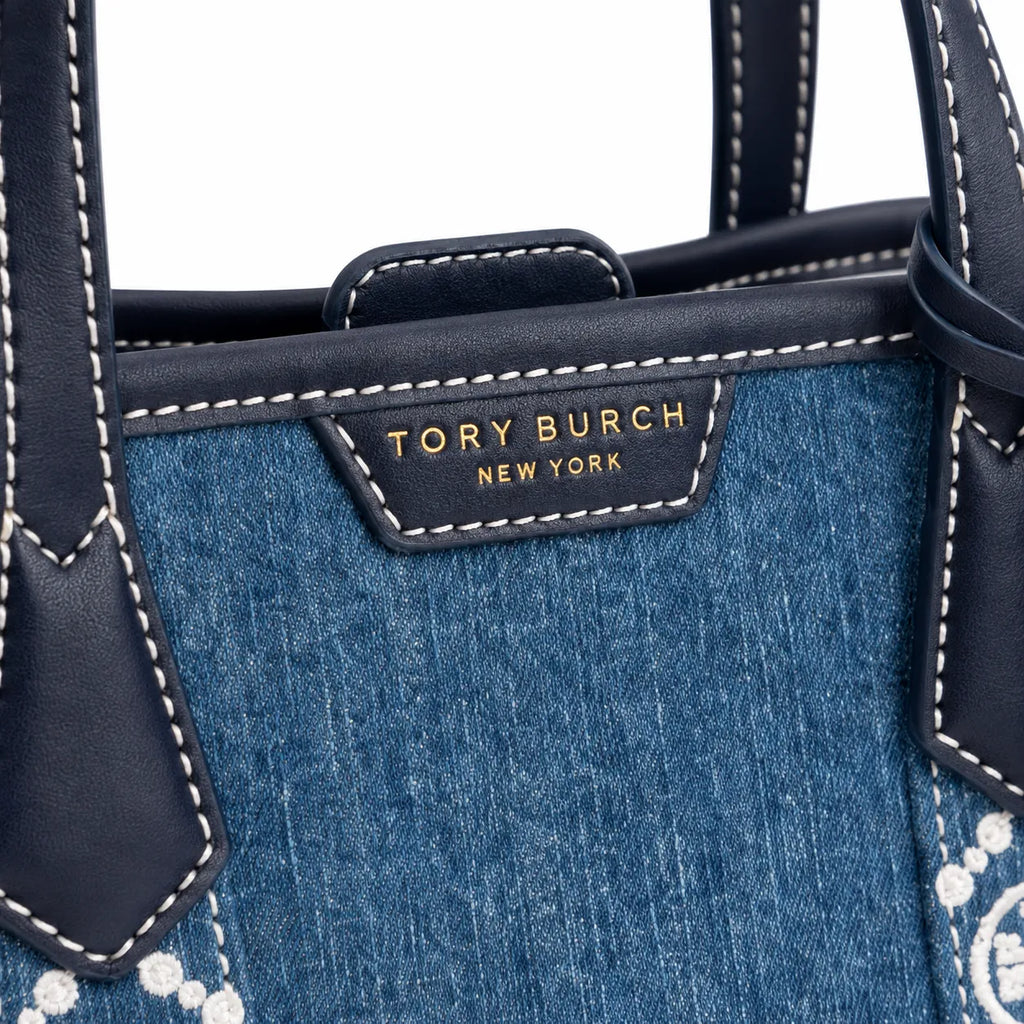 Tory Burch Perry | Blue washed denim  white embroidered T-logo stripes  navy leather trim and gold charm  double handles and adjustable shoulder strap  women's designer shoulder bag