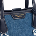 Tory Burch Perry | Blue washed denim  white embroidered T-logo stripes  navy leather trim and gold charm  double handles and adjustable shoulder strap  women's designer shoulder bag