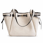 Tory Burch Romy | Off-white women's designer handbag with brown leather trim and drawstring closure adorned with the iconic double-T logo