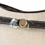Tory Burch Romy | Off-white women's designer handbag with brown leather trim and drawstring closure adorned with the iconic double-T logo