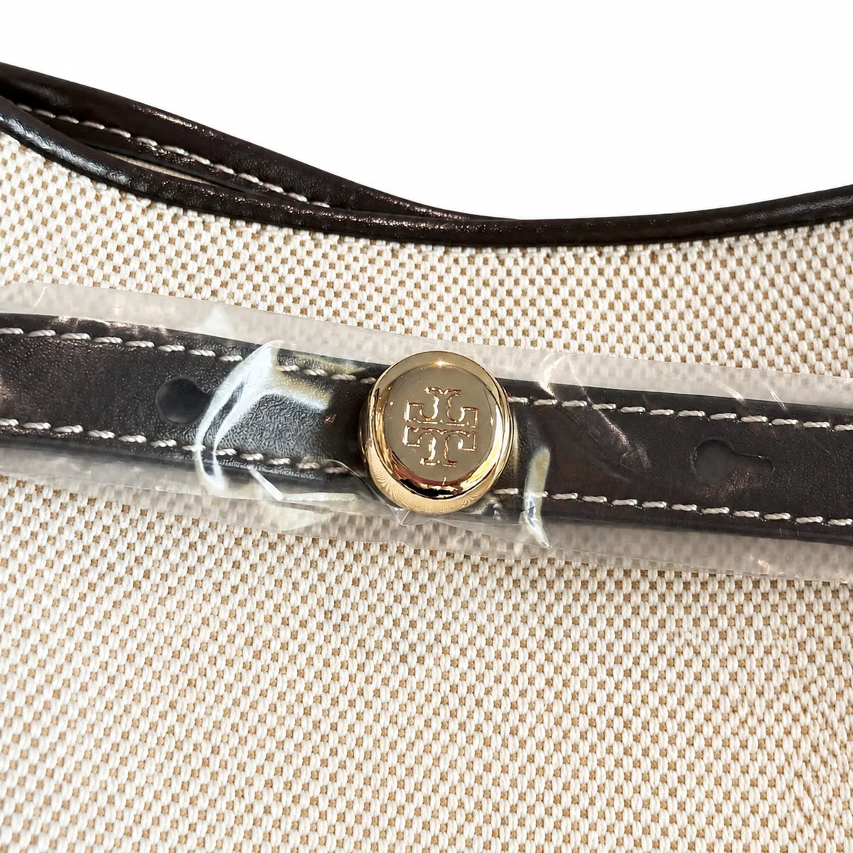 Tory Burch Romy | Off-white women's designer handbag with brown leather trim and drawstring closure adorned with the iconic double-T logo