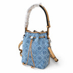Tory Burch T Monogram | Powder blue washed denim with brown leather trim signature double T drawstring closure women's designer handbag
