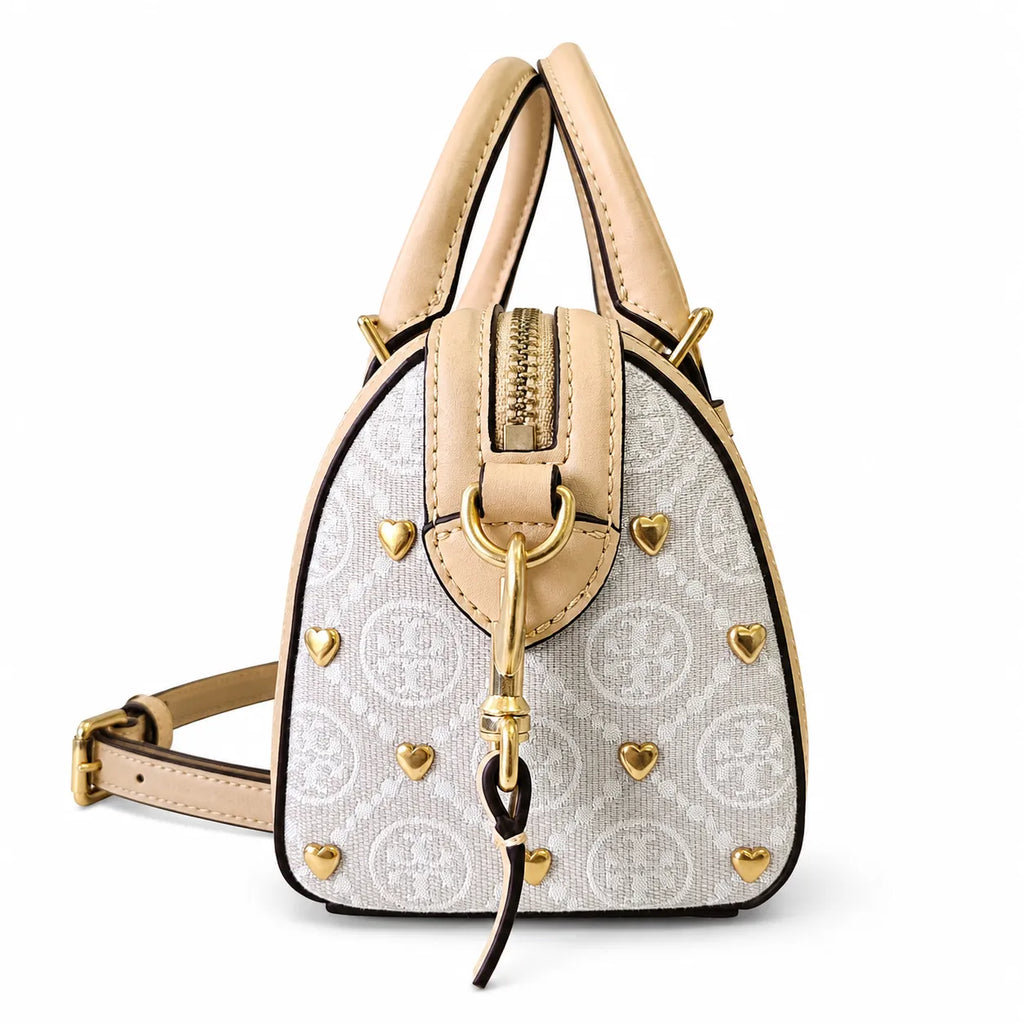 Tory Burch T Monogram | Ivory canvas with tan leather trim  gold heart studs and double T logo adjustable shoulder strap   women's designer handbag