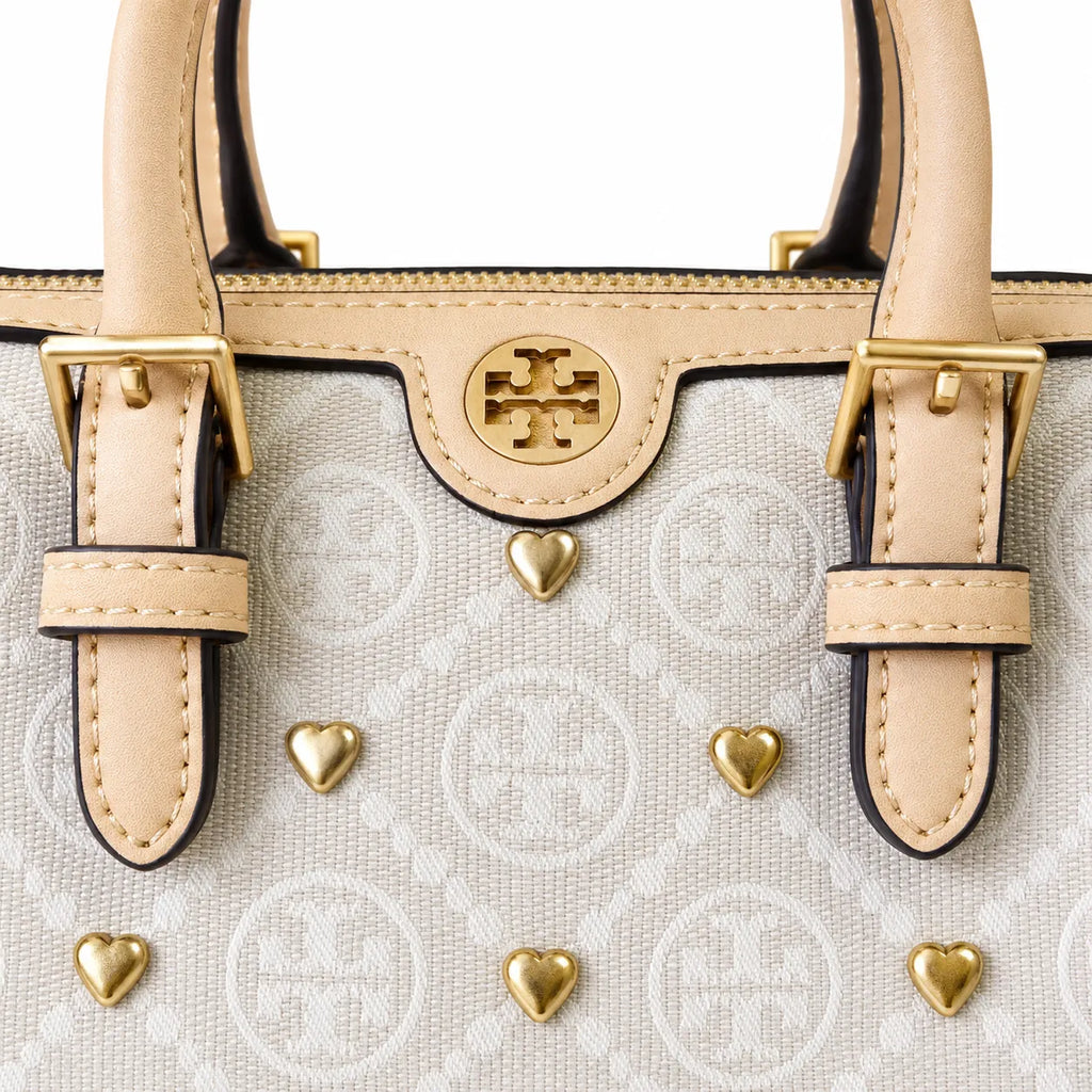 Tory Burch T Monogram | Ivory canvas with tan leather trim  gold heart studs and double T logo adjustable shoulder strap   women's designer handbag