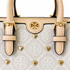 Tory Burch T Monogram | Ivory canvas with tan leather trim  gold heart studs and double T logo adjustable shoulder strap   women's designer handbag