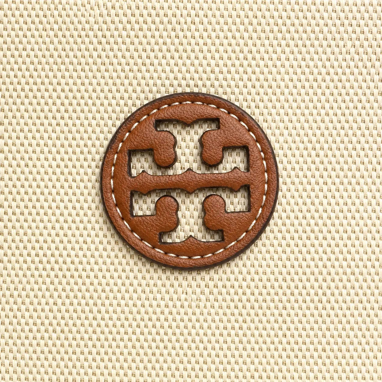 Tory Burch Blake | A women's designer handbag in beige canvas and brown leather with a detachable shoulder strap and top handle offering multiple carrying options