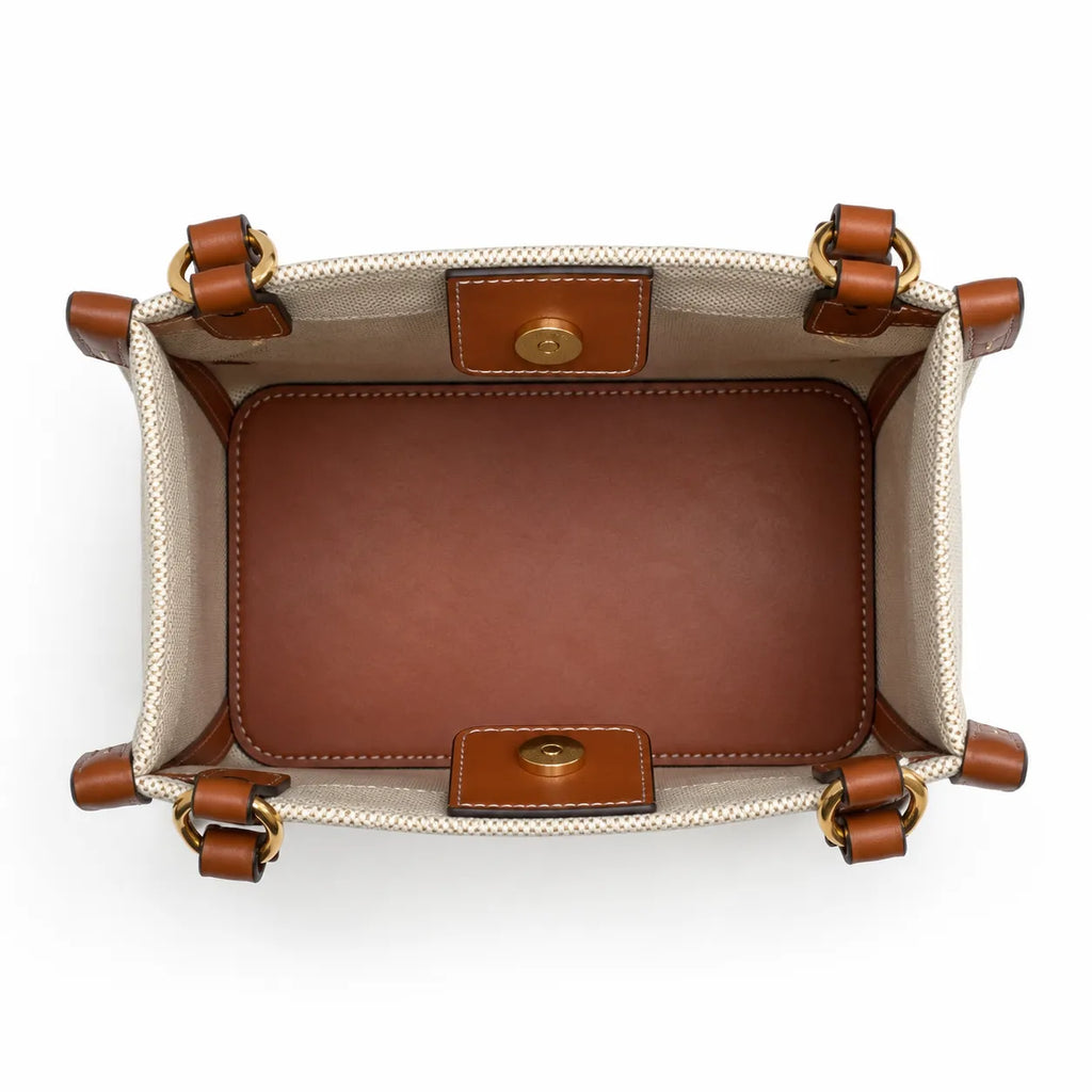 Tory Burch Blake | A women's designer handbag in beige canvas and brown leather with a detachable shoulder strap and top handle offering multiple carrying options