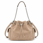 Tory Burch Charlie | Light brown soft suede with diamond stitching drawstring closure and detachable chain A women's designer quilted suede bucket bag offering multiple carrying options