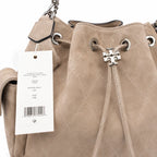 Tory Burch Charlie | Light brown soft suede with diamond stitching drawstring closure and detachable chain A women's designer quilted suede bucket bag offering multiple carrying options