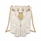 Tory Burch Fleming off-white quilted lambskin with gold logo and tassels  comes with an adjustable chain shoulder strap for multiple carrying options a women's designer handbag