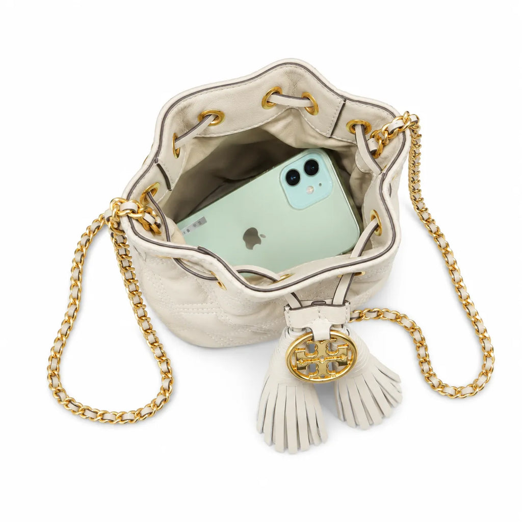 Tory Burch Fleming off-white quilted lambskin with gold logo and tassels  comes with an adjustable chain shoulder strap for multiple carrying options a women's designer handbag