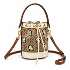 Tory Burch T Monogram | Hazelnut brown Monogram fabric beige leather trim adjustable shoulder strap drawstring closure limited edition women's mini rabbit embroidered bucket bag