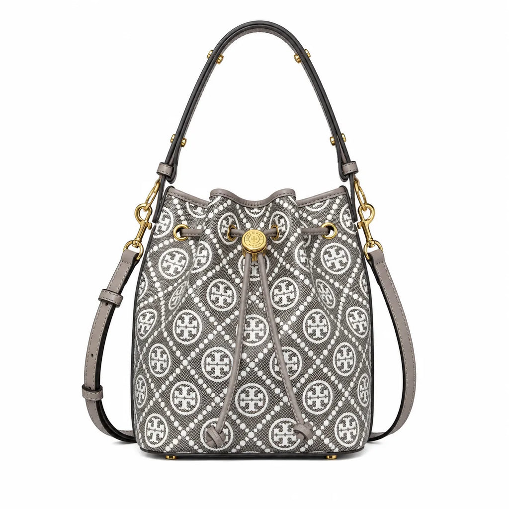 Tory Burch T Monogram bag in grey and white letter jacquard fabric with leather trim drawstring closure and versatile design perfect for commuting and travel